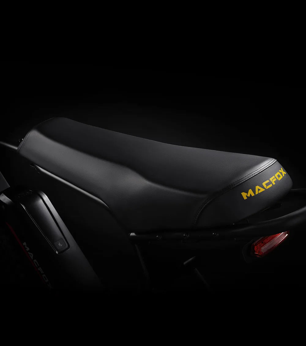 Black motorcycle seat with 'MACFOX' branding on a dark background