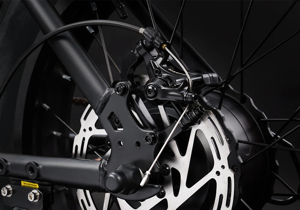 Close-up of a motorcycle brake system with dark background