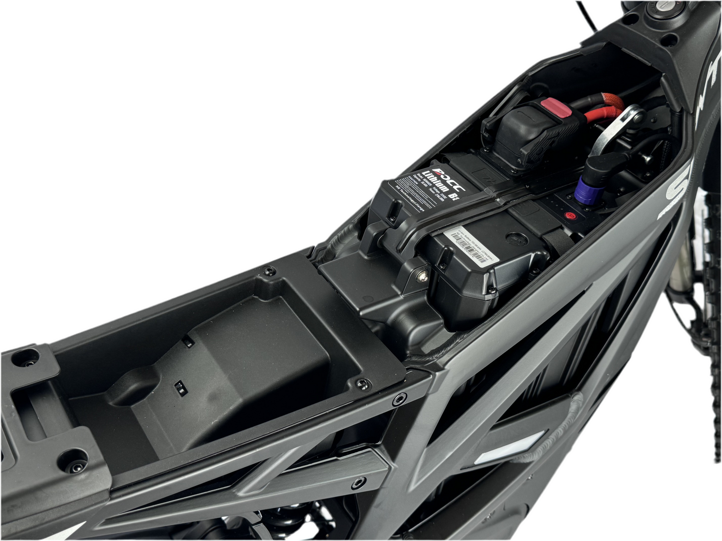Close-up of a motorcycle's undercarriage with visible components on a white background
