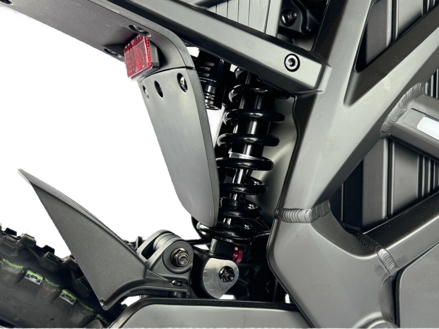 Close-up of a motorcycle suspension system with a white background