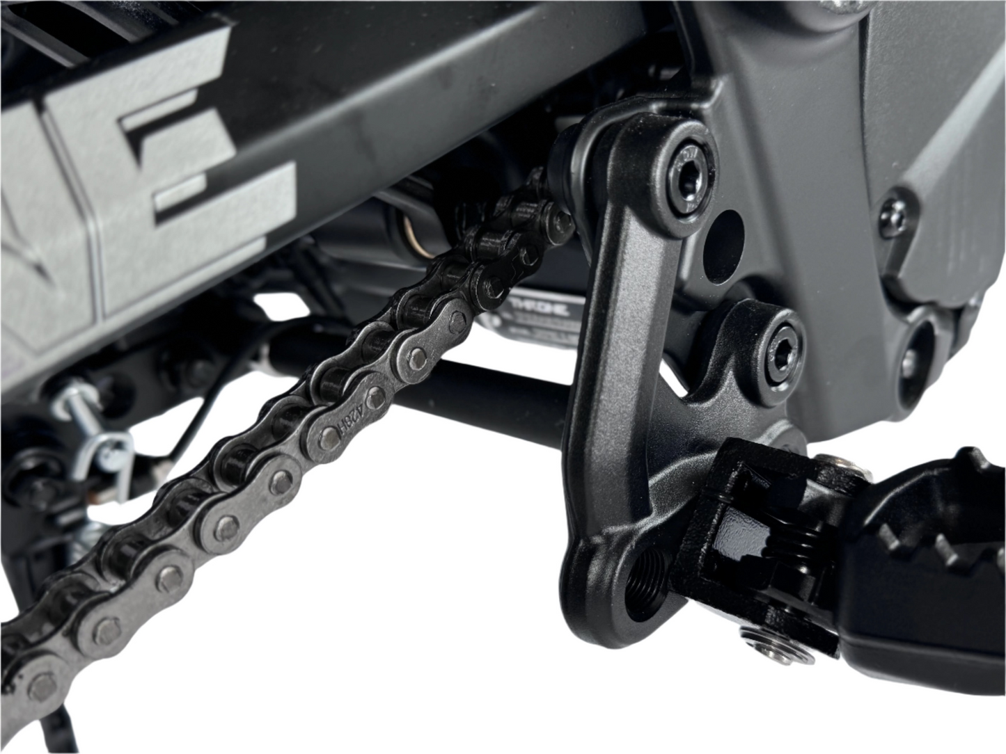 Close-up of a motorcycle chain and sprocket on a white background