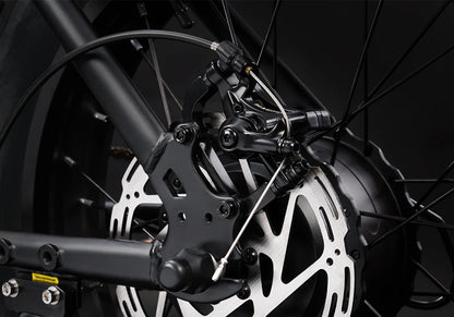 Close-up of a motorcycle brake system with dark background