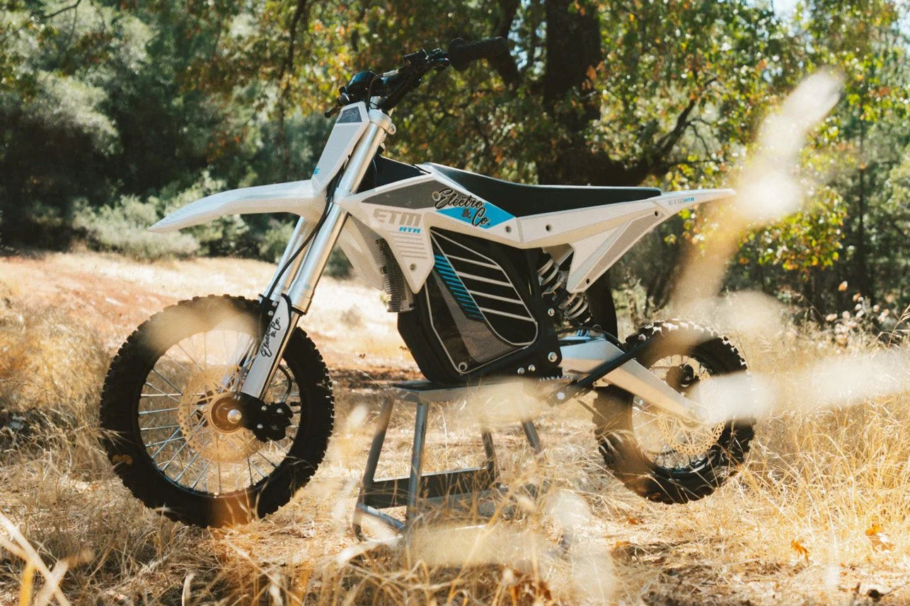 Electric bike in action on a dirt path with trees in the background