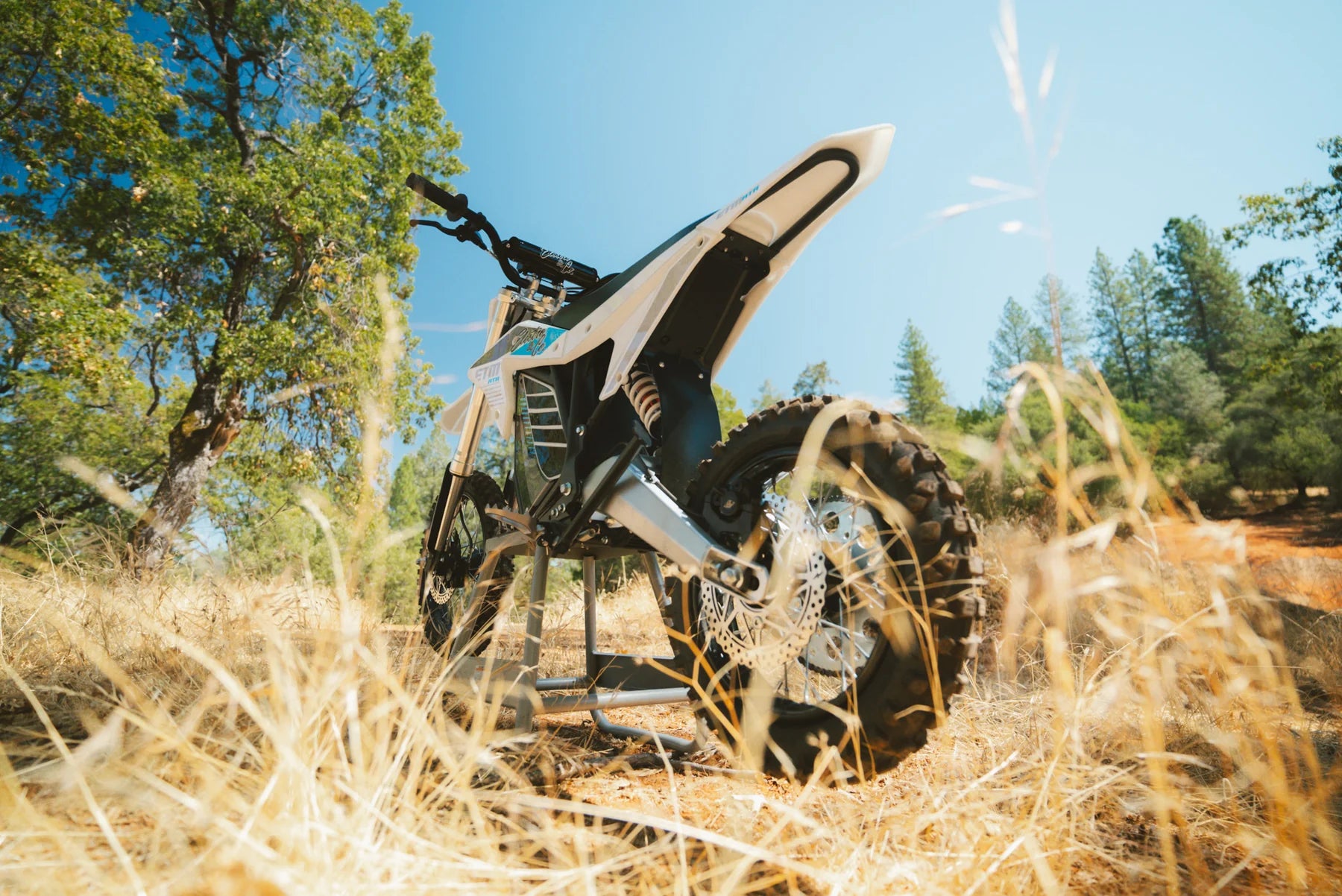 Motorcycle in a natural setting with trees and blue sky
