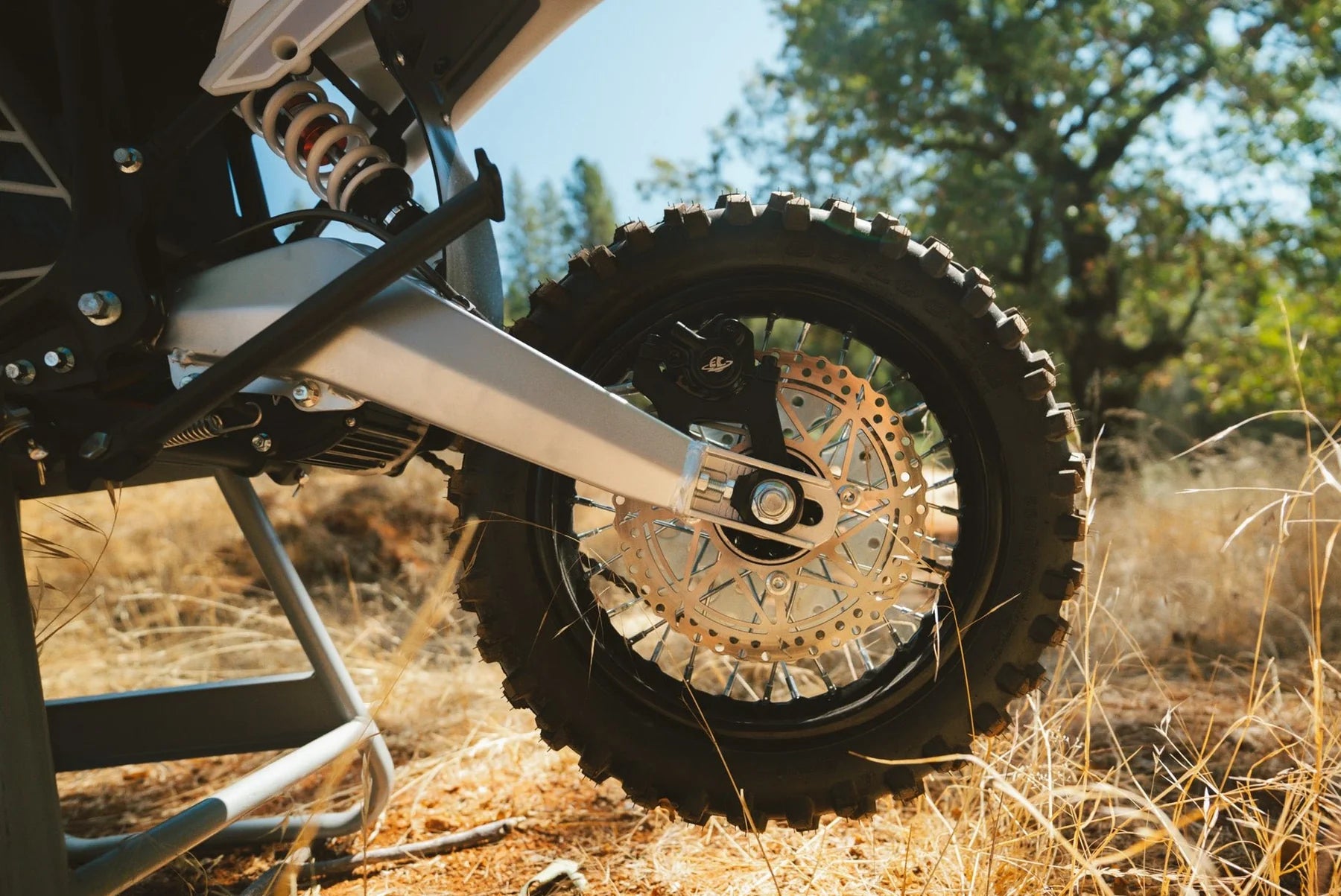 Close-up of a motorcycle wheel with a natural background