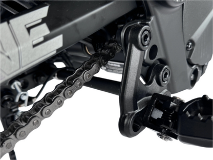 Close-up of a motorcycle chain and sprocket on a white background